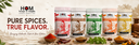 HOM spice packaging with text 'PURE SPICES. TRUE FLAVOR.' on a wooden surface with spices and herbs.
